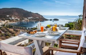 a table with food and a view of the ocean at Theologos Houses in Grikos