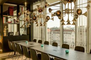 a conference room with a long table and chairs at Motel One Leipzig-Post in Leipzig +36 photos