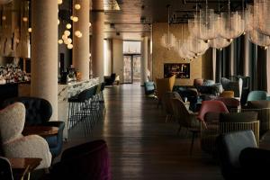 a restaurant with tables and chairs and chandeliers at The Cloud One Prague in Prague +31 photos
