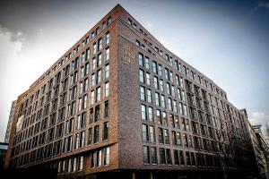 a tall brick building with a lot of windows at The Cloud One Hamburg-Kontorhaus in Hamburg