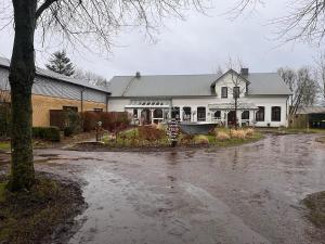 a white house with a flooded street in front of it at Wohnen in der ehemaligen Bauernstube in Treia