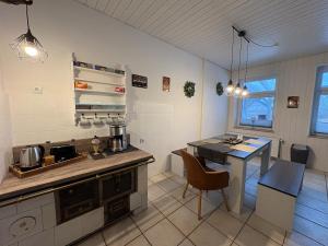 a kitchen with a counter and a table in a room at Wohnen in der ehemaligen Bauernstube in Treia