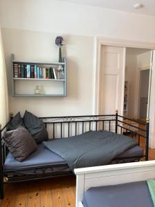 a bed sitting in a room with a shelf at Wohnen in der ehemaligen Bauernstube in Treia