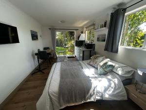 a bedroom with a bed and a desk and a window at Dove Cottage in Oakdale