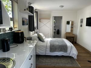 a bedroom with a bed in the middle of a kitchen at Dove Cottage in Oakdale