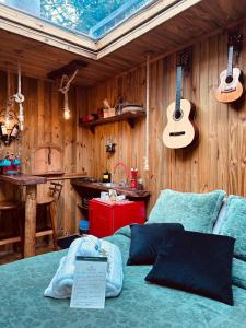 a bedroom with a bed with a laptop on it at Cabana da Árvore e Cabana Retrô - ForestPlace in Monte Verde +32 photos
