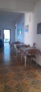 a room with tables and chairs on a tile floor at B&B Don Orlando in Pizzo +14 photos