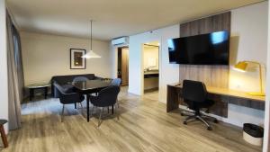a living room and dining room with a table and chairs at Holiday Inn Fortaleza by IHG in Fortaleza