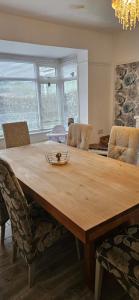 a wooden table in a living room with chairs at Sandringham House in Stockton-on-Tees +10 photos