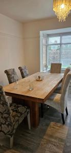 a wooden dining room table with chairs and a chandelier at Sandringham House in Stockton-on-Tees