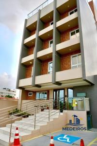 a building with orange cones in front of it at Apartment 201 / Oceanfront / Mirrored Bed / Kitchen in João Pessoa