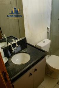a bathroom with a sink and a toilet at Apartment 201 / Oceanfront / Mirrored Bed / Kitchen in João Pessoa