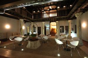a room with tables and chairs in a building at Evenia Alcalá Boutique Hotel in Alcalá de Henares