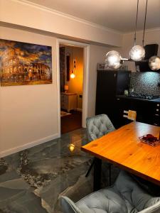 a dining room with a table and a painting on the wall at GZP Residence Lugoj 14 in Lugoj