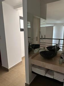 a bathroom with a sink and a large mirror at Apart Maral Zárate in Zárate +40 photos