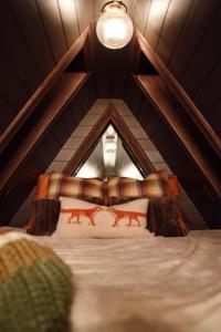 a bedroom with a bed in a attic at Romantic AFrame Cabin with Firepit, BBQ in Pocono Pines