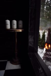 a group of candles on a stand in a room with a fireplace at Romantic AFrame Cabin with Firepit, BBQ in Pocono Pines