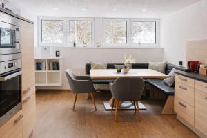 a kitchen and dining room with a table and a couch at Haus Dienten Apartments nahe den Bergbahnen mit HochkönigCard in Dienten am Hochkönig