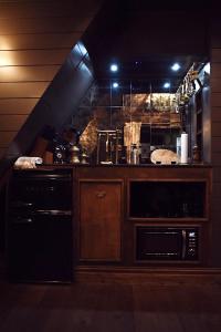 a kitchen with a stove and a sink in a room at Romantic AFrame Cabin with Firepit, BBQ in Pocono Pines