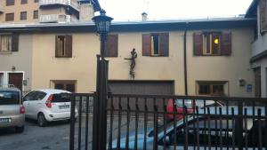 a building with a car parked in front of it at Gufo Depandance in Bormio