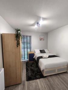 a bedroom with a large bed and a window at Ensuite premier rooms in Basildon