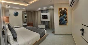 a bedroom with a large bed in a room at Hotel Red Rose in Vadodara