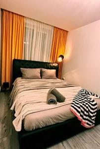 a bedroom with a large bed with a blanket at GZP Residence Lugoj 19 in Lugoj
