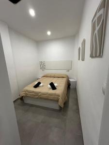 a bedroom with a bed with two pillows on it at MariaValiente in Montoro