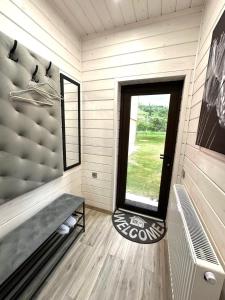 a small room with a window in a tiny house at Котедж RIVERHILL 2-4 осіб in Slavske