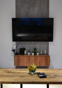 a flat screen tv sitting on top of a wooden table at NovAS Apartment in Mavrovo