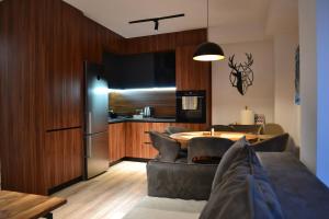 a kitchen and dining room with a table and chairs at NovAS Apartment in Mavrovo