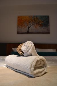 a towel sitting on top of a bed at NovAS Apartment in Mavrovo