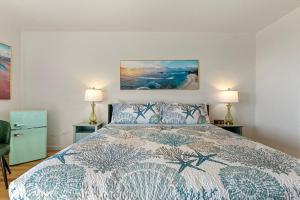 a bedroom with a large bed with two lamps at Crescent Beach Motel in Crescent City