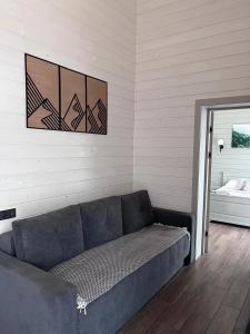 a blue couch in a room with a window at Котедж RIVERHILL 2-4 осіб in Slavske +31 photos