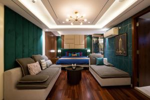 a hotel room with a bed and a couch at Hotel TOS Residency Jubilee hills in Hyderabad