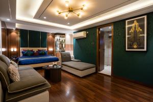 a living room with a bed and a couch at Hotel TOS Residency Jubilee hills in Hyderabad