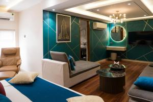 a living room with a blue and green wall at Hotel TOS Residency Jubilee hills in Hyderabad +21 photos