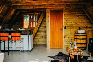 a cabin with a staircase and a table and chairs at Olivas Eco Chalé in Pouso Alto