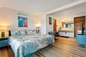 a bedroom with a bed and a bathroom at Crescent Beach Motel in Crescent City
