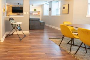 a living room with a table and chairs and a couch at Lovely CWE 2BR with Private Parking ABODEbucks in Saint Louis