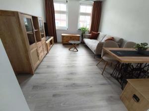 a living room with a couch and a table at Michas FeWo in Bautzen