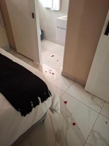 a bedroom with a bed with red roses on the floor at The Serenity-Apartment 2 in Sandton