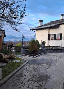 a house with a stone walkway in front of it at Cjase Cumine in Lauco +41 photos