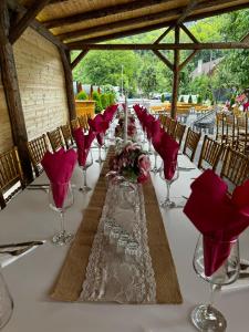 a long table with wine glasses and flowers on it at CASA HOBAN in Baia Mare