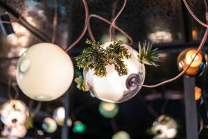 a bunch of lights hanging from a ceiling at Motel One Berlin-Mitte in Berlin