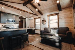 a living room with a couch and a kitchen at Teton Valley Resort in Victor