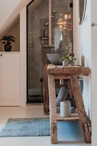 a wooden table with plants on it in a room at Stylish downtown loft and opposite park in Maldegem +53 photos