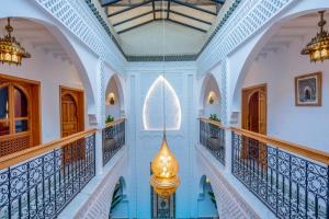 a hallway in a house with blue walls and ceilings at Riad Secret De Medina in Marrakesh