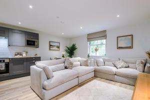 a living room with a couch and a kitchen at Rock Mill - The Penthouse Suite in Stony Middleton