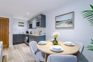 a kitchen and dining room with a table and chairs at Rock Mill - The Penthouse Suite in Stony Middleton